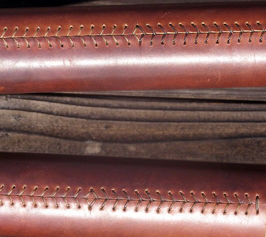 Stitching on oar leathers.