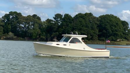 Mast & Mallet Custom Picnic Style Skiff, in water, port side