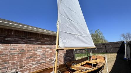 Arch Davis Penobscot 13’ Skiff, on trailer, sail up, port side bow view