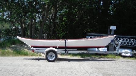 Custom wooden row boat, on trailer, starboard side view