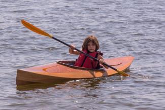 FLORA B., a Chesapeake Light Craft Wood Duckling kayak.