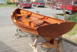 Bright finished inside and out, the Sid skiff sits awaiting launch.