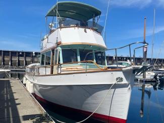 Well Maintained True Classic Grand Banks, in water docked bow starboard side view