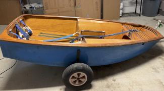 English Wooden Optimist Dinghy – Hull No. K3658, starboard side view, in storage
