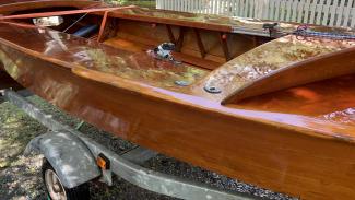 GERBER ALL-VARNISHED WOODEN SNIPE SAILBOAT, on trailer port side view