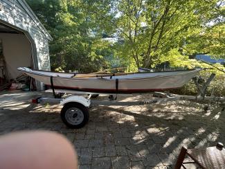 Custom wooden row boat, on trailer port side view