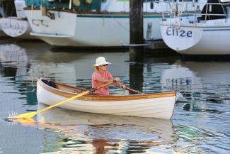 Kirdy, in water being rowed