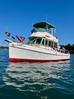 Well Maintained True Classic Grand Banks, in water port side bow view
