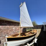 Arch Davis Penobscot 13’ Skiff, on trailer, sail up, port side bow view