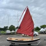 Shellback dinghy—a classic Joel White design, on trailer sail up starboard side view