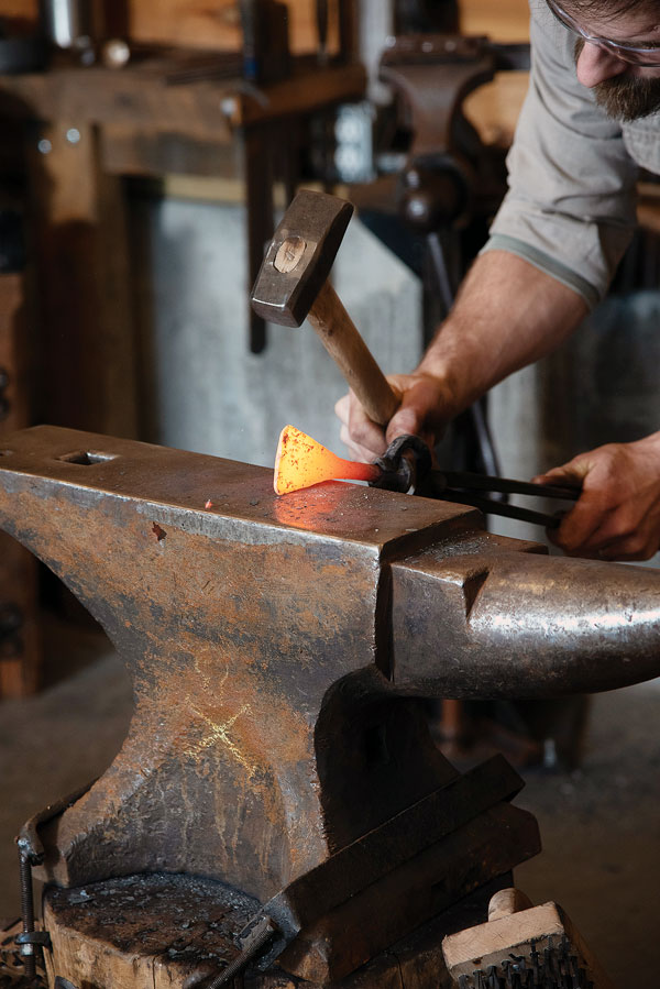 The process of drawing and spreading the blade requires numerous trips from the forge to the power hammer.