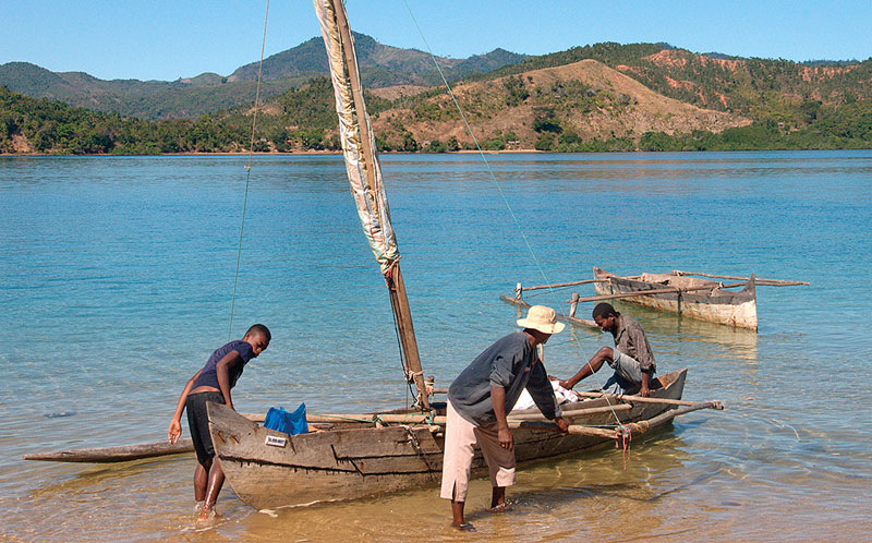 Fishermen launching their canoe.