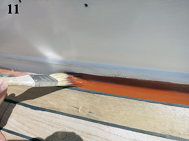 Brushing paint.