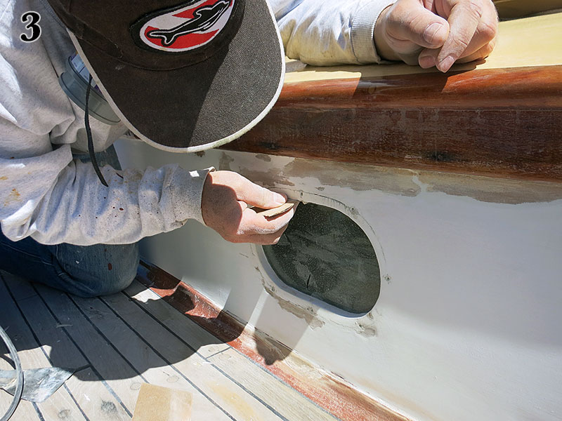Sanding with a square-pad orbital sander.