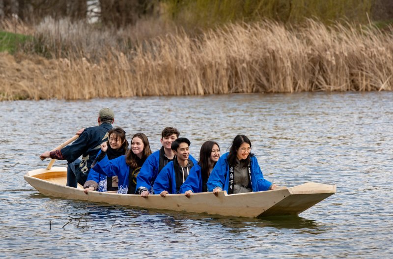 Photo by Fred Zwicky at University of Illinois Urbana-Champaign. Students aboard the boat in the Japan House pond.