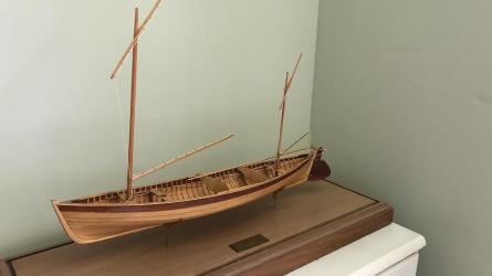 "Piccolo" 12' 8" Sailing Canoe and Model, on display port side view