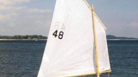SHELLBACK SKIFF, in water sails up starboard side view