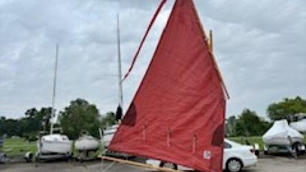 Shellback dinghy—a classic Joel White design, on trailer sail up starboard side view