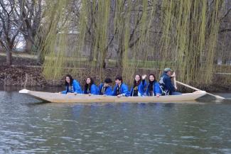 Brooks and students aboard the boat in the Japan House pond.