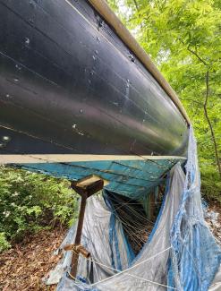 1920 Herreshoff S Boat in need of restoration , on stands view of underneath