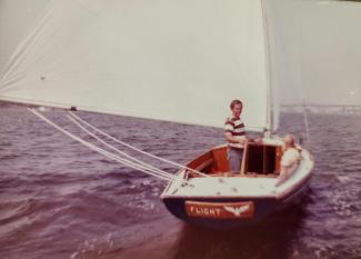 1920 Herreshoff S Boat in need of restoration , undersail in water stern view