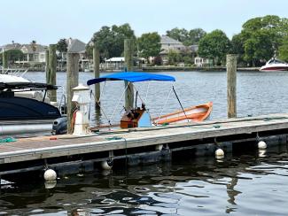 2018 Wooden Seaskiff, docked on starboard side, awning up