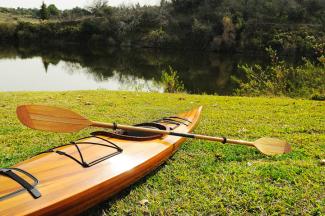 Wooden Kayak Miramichi 17'  - 1 person, view on grass with paddle