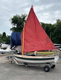 Shellback dinghy—a classic Joel White design, on trailer sail up port side view