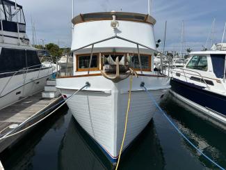 1969/1975 Monk Sr. Trawler, in water docked bow view