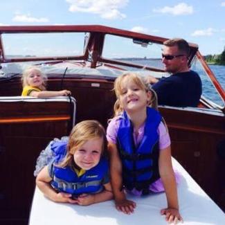 Family on a cruise down Snows Channel, Les Cheneaux Islands, MI