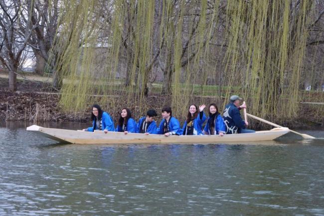 Brooks and students aboard the boat in the Japan House pond.