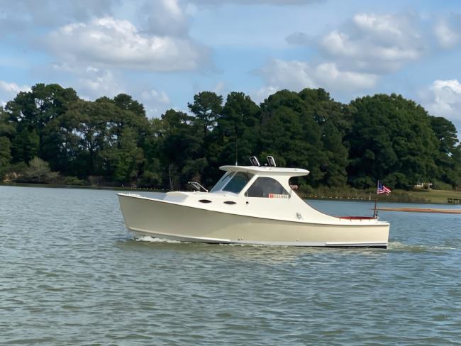 Mast & Mallet Custom Picnic Style Skiff, in water, port side