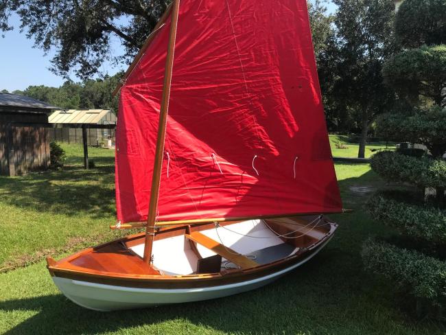 SHELLBACK SAILING DINGHY, on the grass port side, inside view, sail up