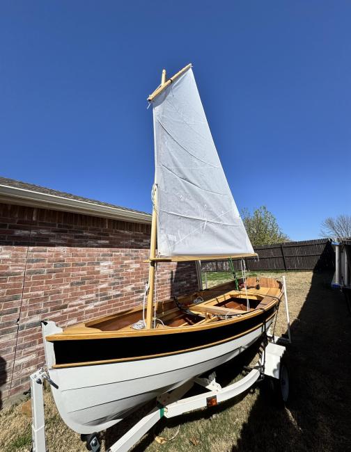 Arch Davis Penobscot 13’ Skiff, on trailer, sail up, port side bow view