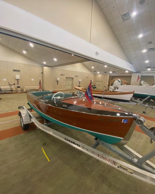Great Wooden Boats Available for Sale & Lease, chris craft on trailer at boat show starbaord side bow end view