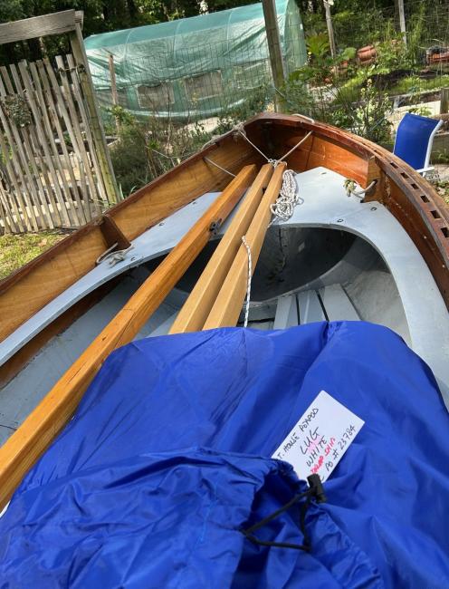 Chesapeake Light Craft Peapod, on trailer inside of boat