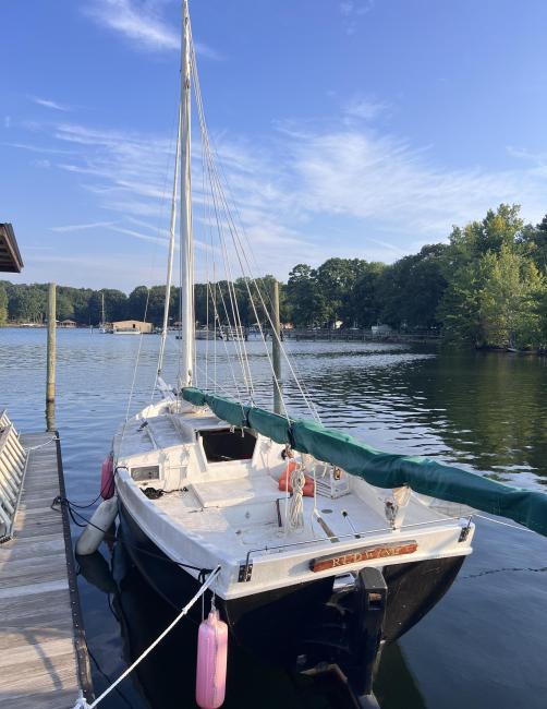 Custom Phil Bolger Wooden Triple-Keel Sloop, docked port side stern view