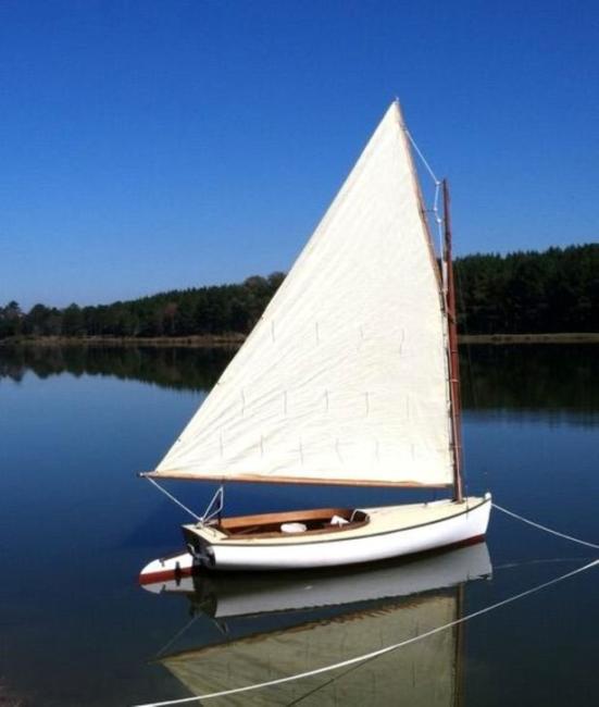 Catboat "Dell", sail up on mooring, starboard side view