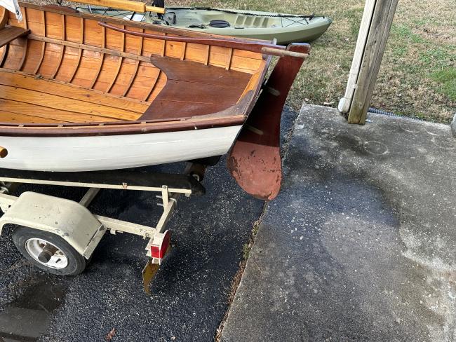 Cats paw dinghy row and sail,  view of stern, on trailer