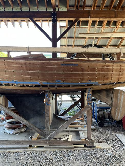 Wooden ballast keel sloop "RASCAL", on stands inside port side view, keel