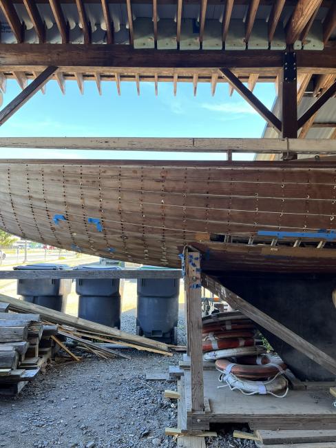 Wooden ballast keel sloop "RASCAL", on stands inside port side view, keel
