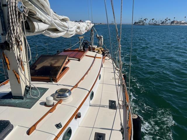 "MERRYWING" A 39' sloop, view looking out over bow from on deck, starboard side