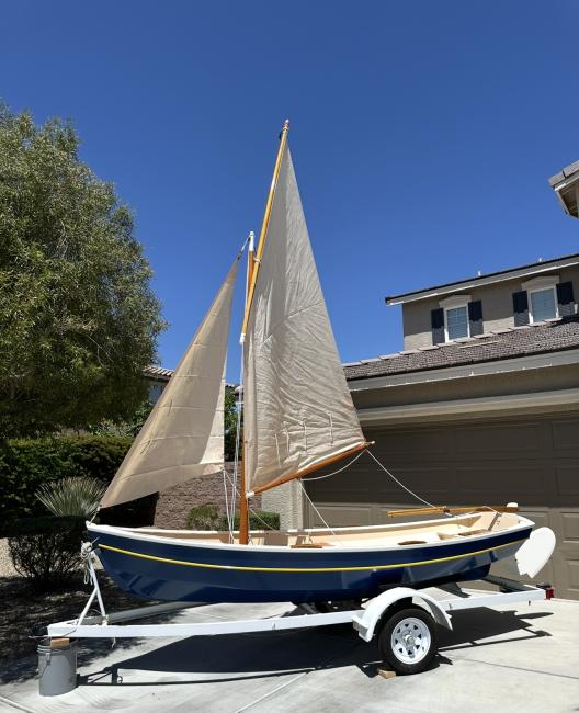 For Sale: 12'-10" Pooduck Skiff, on trailer sails up portside view
