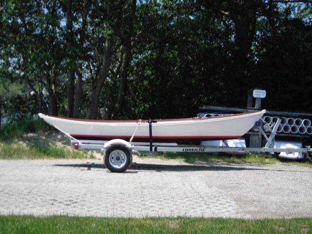 Custom wooden row boat, on trailer, starboard side view