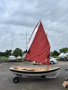Shellback dinghy—a classic Joel White design, on trailer sail up starboard side view