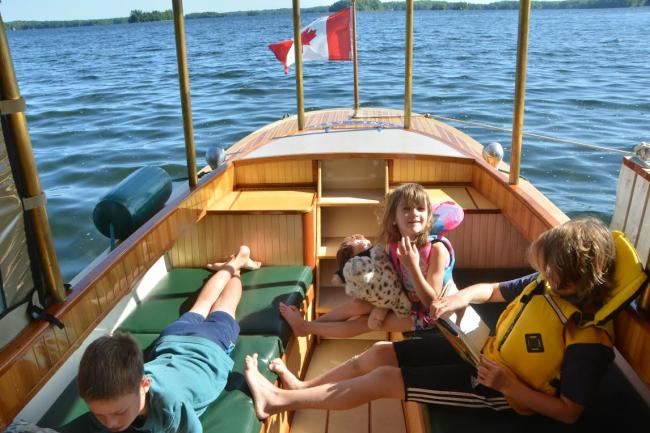 Sparks 30' electric/solar/diesel , on deck looking toward stern kids having the time of their life