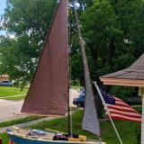 FAMILY TIME at home on trailer with sails full and US flag in front driveway.