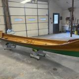 New Adirondack Guide Boat for Sale, on stands, inside