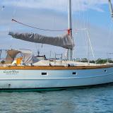 Cold-molded sloop Ceol Mor for sale, on mooring in water, starboard side stern end view