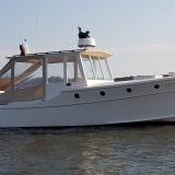 Doug  Hylan Bowler 26' 6" Power Cruiser , in water starboard side view